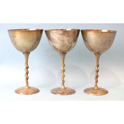 Three Stuart Devlin parcel-gilt silver goblets, each with gi...