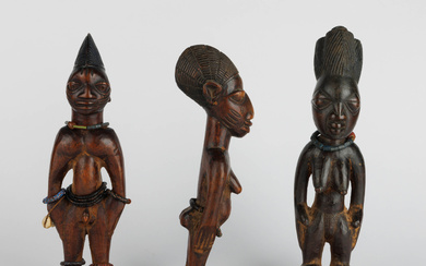 Three Yoruba ibeji figures of which two female and one male. Nigeria. Early 20th century.