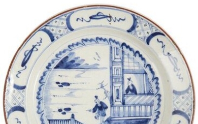 31-Delft: a large earthenware dish with blue monochrome decoration depicting...