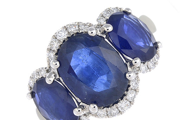 A sapphire three-stone and diamond ring.