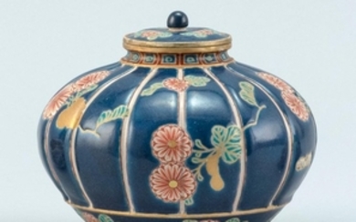 SATSUMA POTTERY COVERED JAR In melon form. Ribbed body decorated with leaves and flowers on a blue ground. Diameter 5".