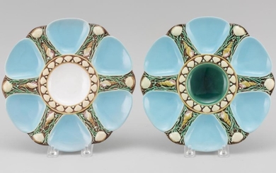 TWO MINTON MAJOLICA OYSTER PLATES One with an emerald green center and the other with a cream-colored center. Impressed marks. Year...