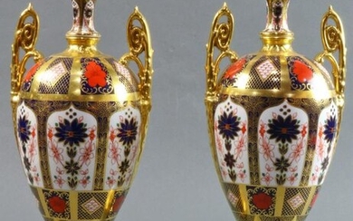 A pair of Royal Crown porcelain urns