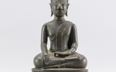TIBETAN BRONZE FIGURE OF BUDDHA Seated in an earth touching position on a raised oval base. Height 11.5".