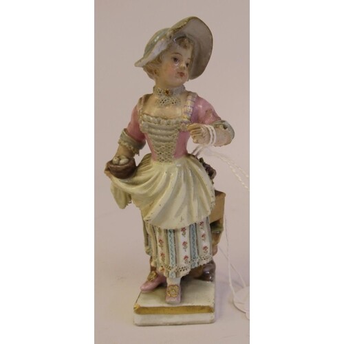 A 19th/20thC Meissen porcelain figure, a girl carrying a bas...