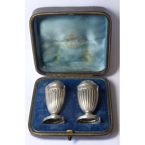 A CASED PAIR OF VICTORIAN C SILVER PEPPERETTES Classical for...