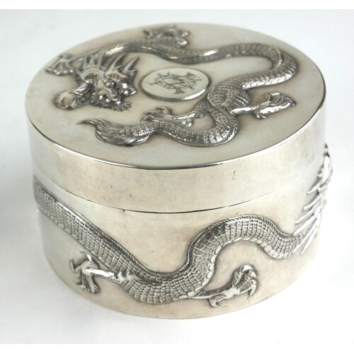 A CHINESE SILVER CIRCULAR BOX AND COVER Decorated in relief ...