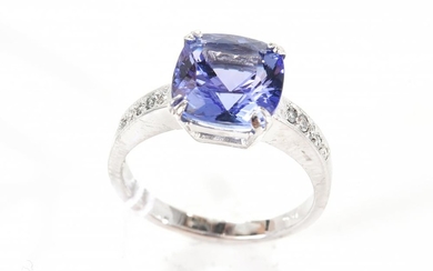 A CUSHION CUT TANZANITE OF 3.40CTS WITH DIAMOND SET SHOULDERS IN 18CT WHITE GOLD.