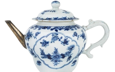 A Chinese blue and white teapot and cover, 18th century, painted to the front and back with panels enclosing floral patterns, with a silver spout, 15cm high Provenance: Collection of the late documentary maker John Armstrong (1928-2004). 十八世紀...