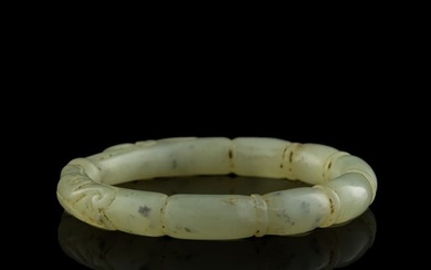 A Chinese carved jade lotus root-form bangle, Qing dynasty
