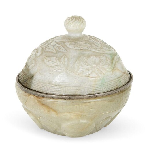 A Chinese celadon green jade bowl and associated cover, 19th century, the cover carved in low relief with leafy lotus blooms, enclosing a white metal liner, 6cm diameter