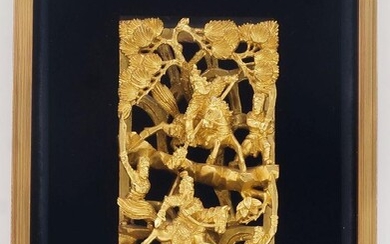 A Chinese gilded and red painted carved wood panel, 20th century, depicting soldiers on foot and horseback, held in a recessed black felt and gilded frame, the panel 24cm x 12.5cm