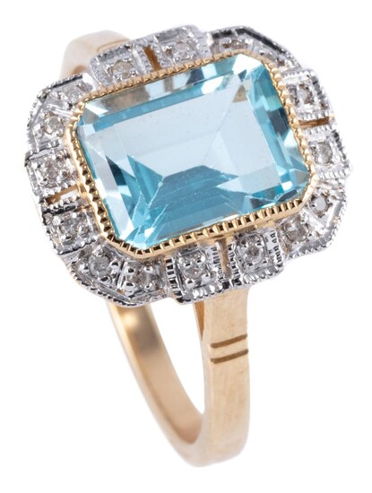 A DECO STYLE TOPAZ AND DIAMOND RING; featuring a step cut light blue topaz to stepped border of round brilliant cut diamonds in 9ct...