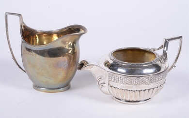 A George III silver circular cream jug by Joseph Guest