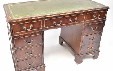 A Georgian-style mahogany twin-pedestal desk, each pedestal with three drawers,...