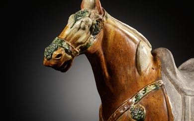 A LARGE AND FINE SANCAI GLAZED APPLIQUÉ-DECORATED POTTERY FIGURE OF A HORSE, TANG DYNASTY
