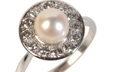 A PEARL AND DIAMOND CLUSTER RING in platinum, set with a cu...