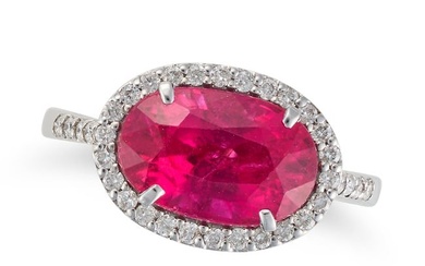 A PINK TOURMALINE AND DIAMOND RING set with an oval cut pink tourmaline of 3.19 carats in a border