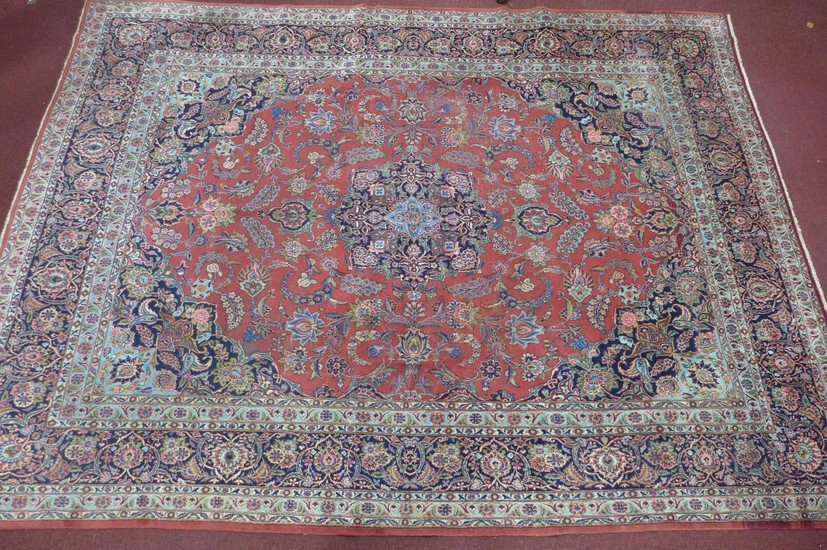 A Persian Kashan carpet, central floral medallion and stylis...
