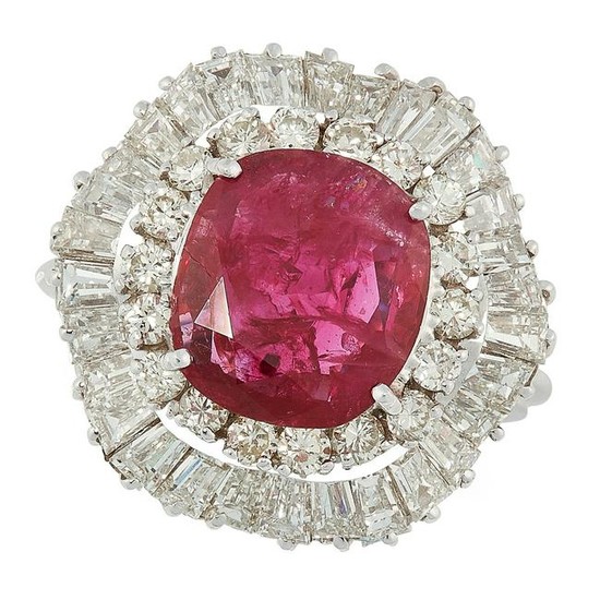 A RUBY AND DIAMOND CLUSTER RING set with a oval cushion
