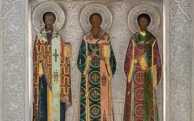 A Russian icon of the Three Hierarchs of Orthodoxy, 1908-1926, marked with 84 standard, Moscow, maker Cyrillic S.G., the three Church Fathers, Basil the Great, Gregory the Theologian, and John Chrysostom, standing full-length wearing elaborately...