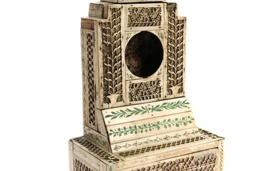 A Russian miniature watch cabinet, richly decorated with carved ivory. Kholmogory in Archangelsk, 19th century. H. 26.5. W. 16. D. 10 cm.