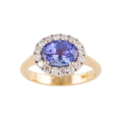 A TANZANITE AND DIAMOND CLUSTER RING, the oval tanzanite to ...