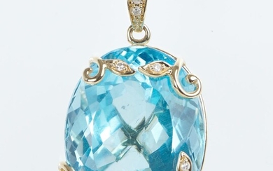 A TOPAZ AND DIAMOND FOLIATE PENDANT IN 9CT GOLD, THE OVAL CUT BLUE TOPAZ WEIGHING 55.79CTS, LENGTH 30MM