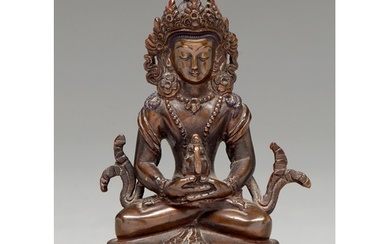 A Tibetan bronze figure of Guanyin 20th c, on double lotus b...