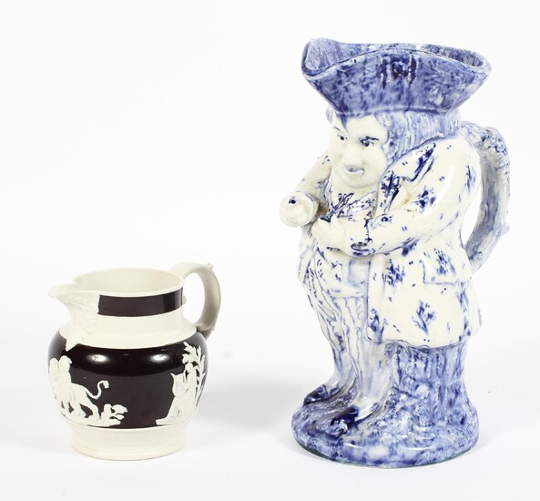 A Victorian stoneware jug and a pottery toby jug