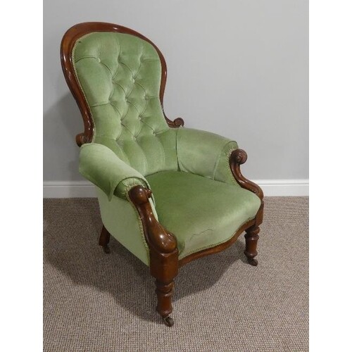 A Victorian walnut gentleman's Armchair, with spoon shaped b...