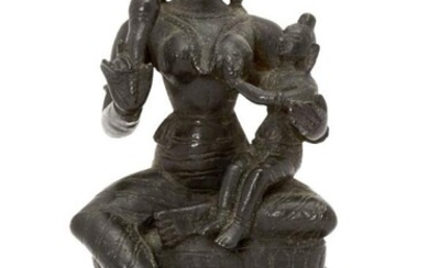 A bronze figure of Yashoda with Krishna,...