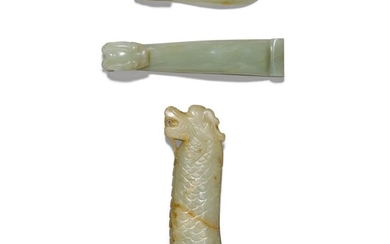 A celadon and russet jade 'dragon' handle and two celadon jade belt hooks Qing dynasty, 19th century | 清十九世紀 褐斑青玉刀柄 及 青玉帶鉤兩件