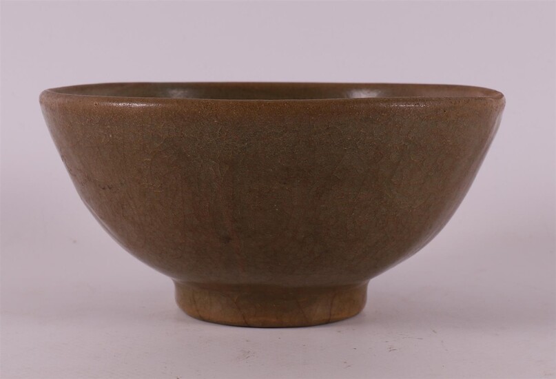 (-), A celadon glazed porcelain bowl on a...
