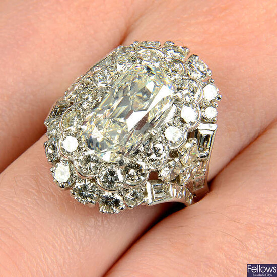 A cushion-cut diamond ring, with brilliant and baguette-cut diamond surrounds.