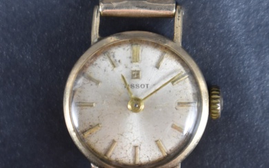 A lady's vintage 9ct gold wrist watch by Tissot having a baton numeral dial to champagne coloured