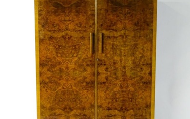 A mid 20thC Art Deco style wardrobe with burr walnut veneered doors. 48" wide x 21" deep x 73" high.