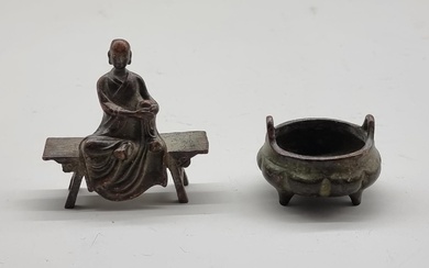 A miniature Chinese bronze twin handled tripod censer, seal ...