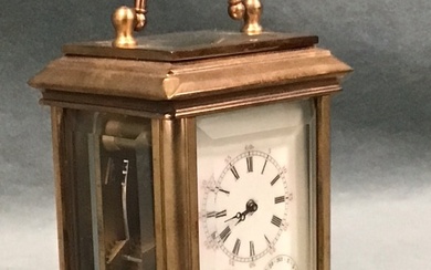 A miniature gilt brass corniche cased carriage clock with bevelled...