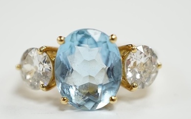 A modern 18ct gold, single stone oval cut aquamarine and two...