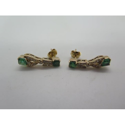 A pair of 18ct yellow gold, tested, emerald and diamond earr...