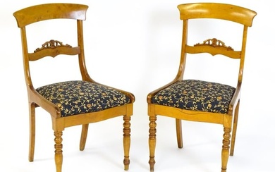A pair of 19thC side chairs with bowed top rails, carved mid rails, drop in seats and raised on