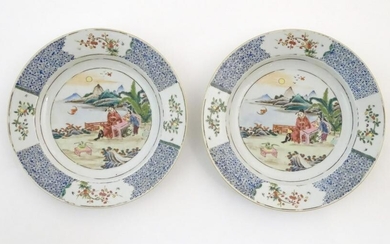 A pair of Chinese plates depicting a two figures in a