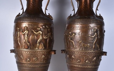 A pair of large Grecian bronze Urns set on a marble base decorated in relief with figures and foliag