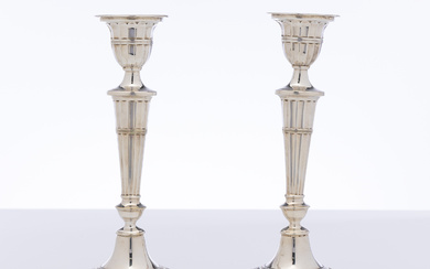 A pair of oval based silverplate candlesticks by Viners of...