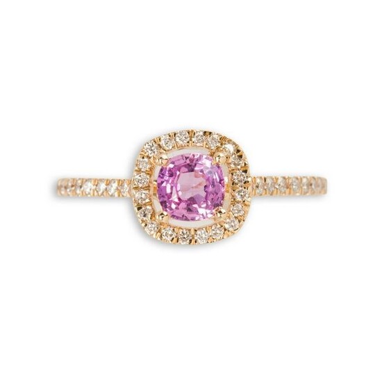 A pink sapphire, diamond and fourteen karat gold ring