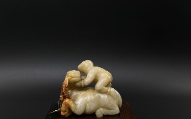 A rare Chinese carved white and russet nephrite figurine...