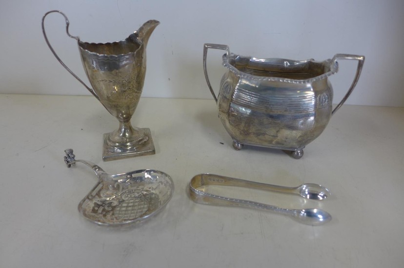 A silver cream jug, a silver sugar bowl, a pair of silver ni...