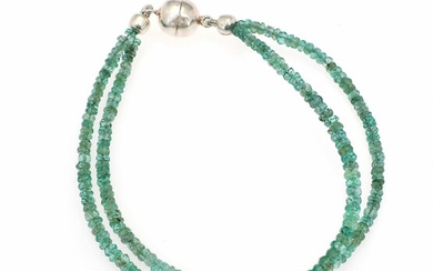 SOLD. A two-strand emerald bracelet set with numerous faceted beads of emerald and a silver-plated...