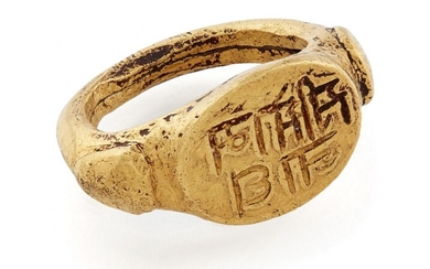 A very rare early gold ring inscribed "Sri Somanath" (Lord Shiva), South India, 10th-11th century, with raised triangular elements to shoulders, the flat oval bezel inscribed and filled with black substance to enhance the inscription, the band...